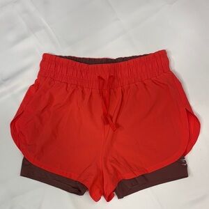GYMSHARK RUNNING 2 IN 1 SHORTS RED AND BROWN ATHLETIC SHORTS.